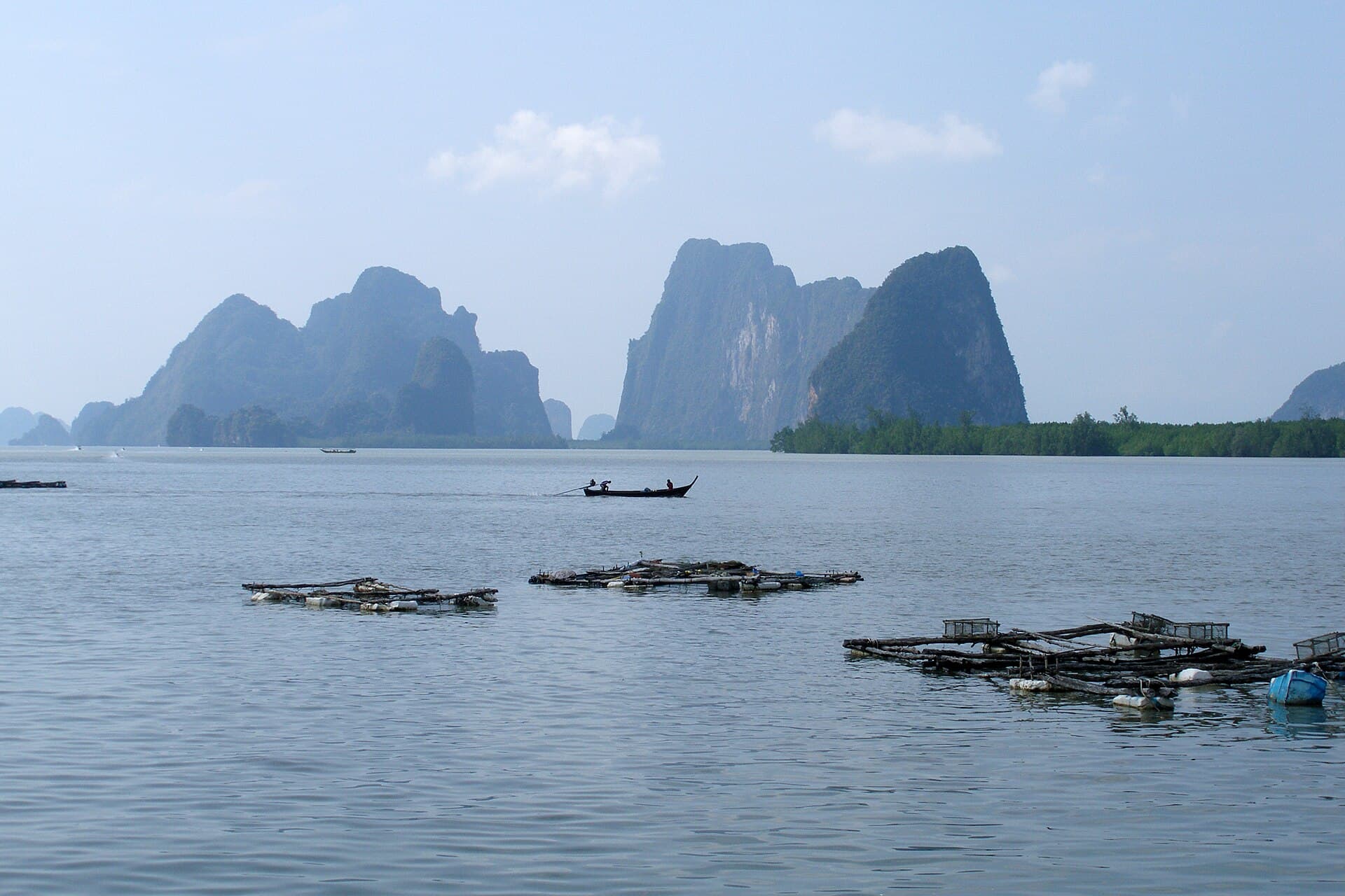 Limestone karst islands rising from the calm water of Phang Nga Bay