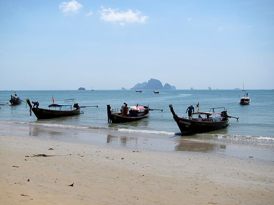 Longtail boats lined up on the sand at Ao Nang beach