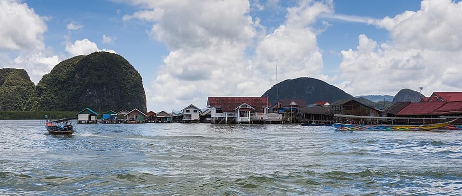 The stilt village of Koh Panyee below a limestone cliff in Phang Nga Bay