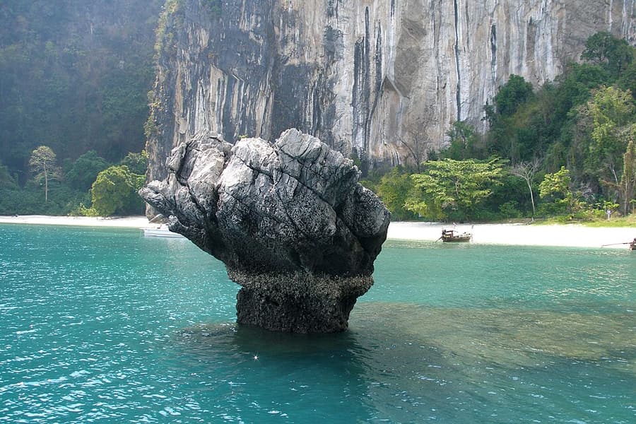 An eroded rock stack in an emerald lagoon in Phang Nga Bay