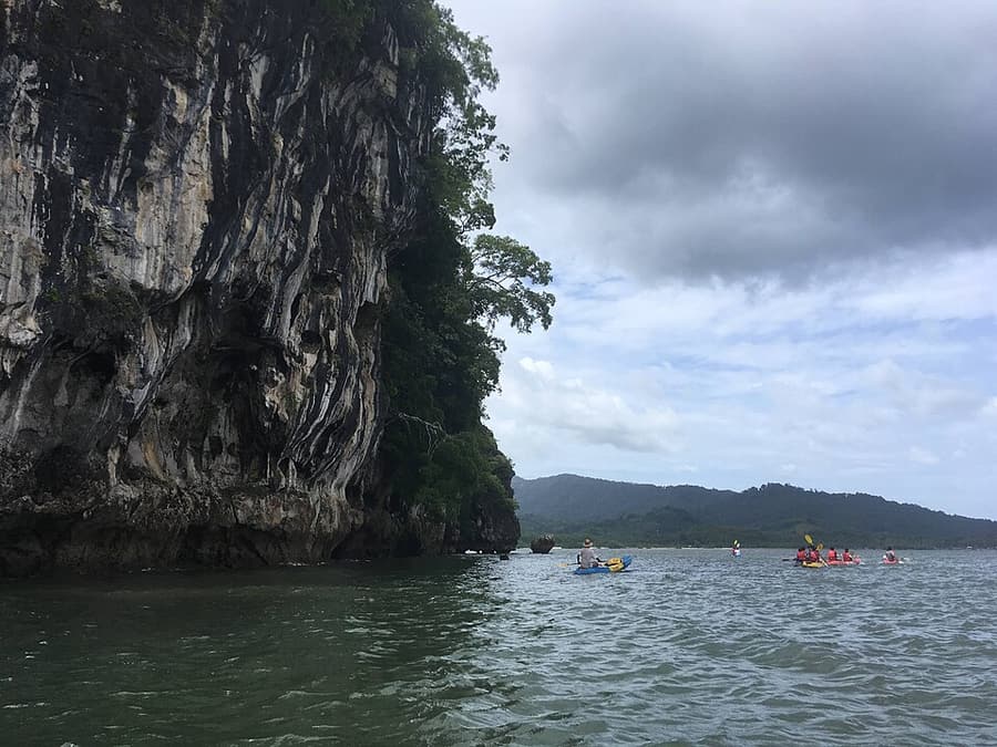 Kayaks between mangroves and limestone walls at Ao Thalane, Krabi